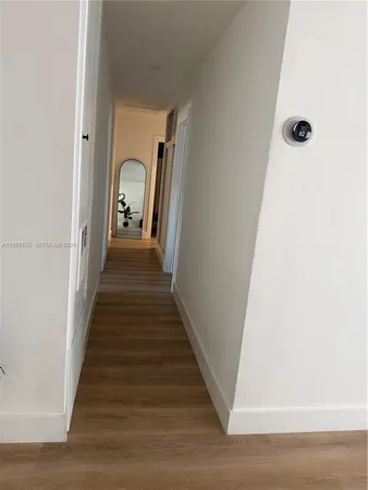 a view of a hallway with a white door