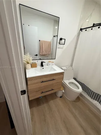a bathroom with a sink mirror vanity and toilet