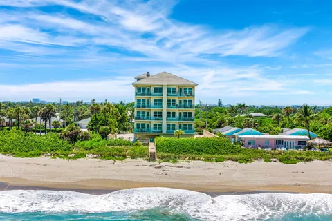 a large kitchen with lots of counter space and glass table