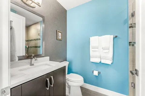 a bathroom with a sink toilet and shower