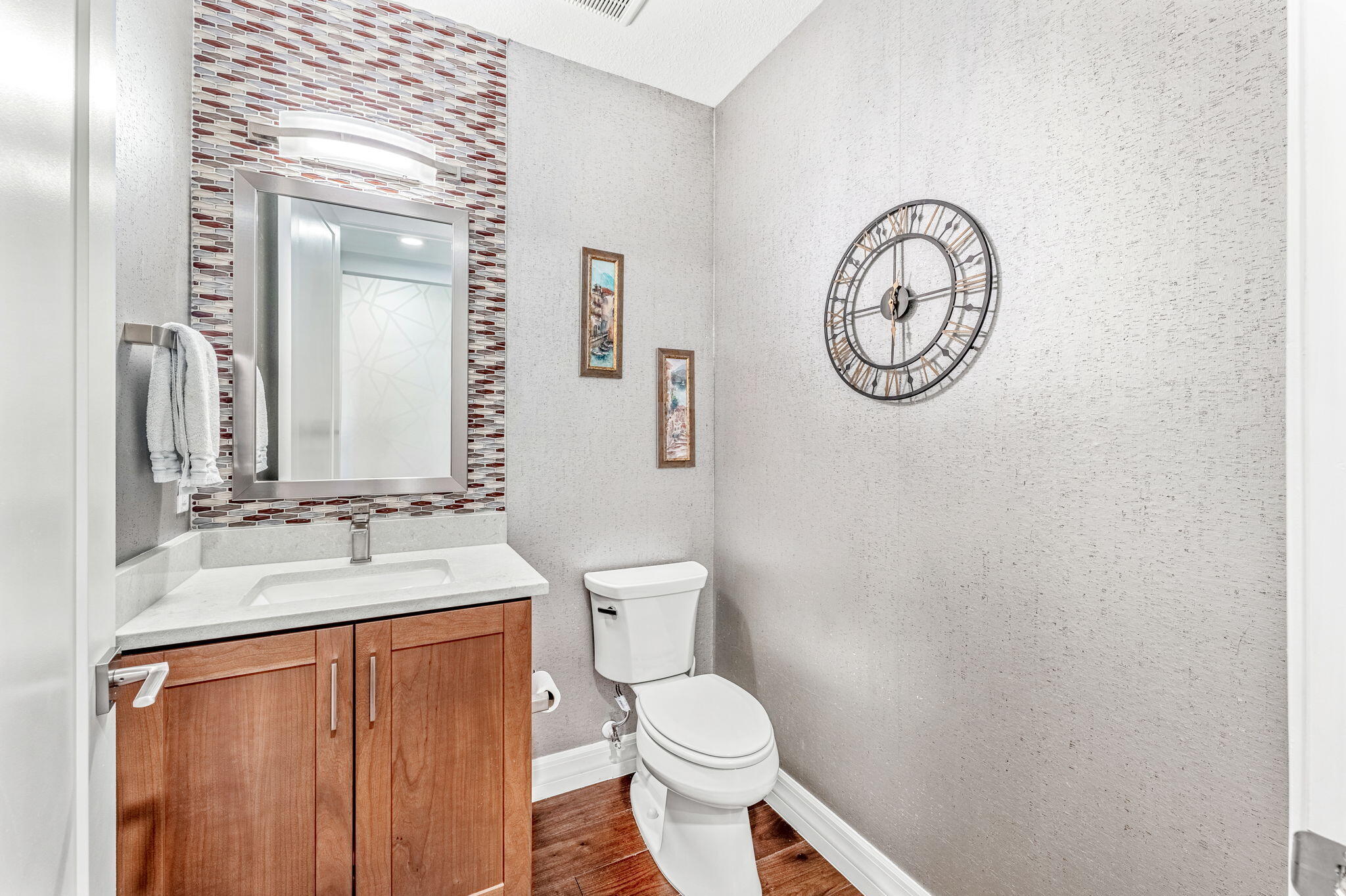 1725 North Hwy A1A, Unit 401 Indialantic, FL 32903 - Photo 23 of 39 a bathroom with a toilet a sink and a mirror