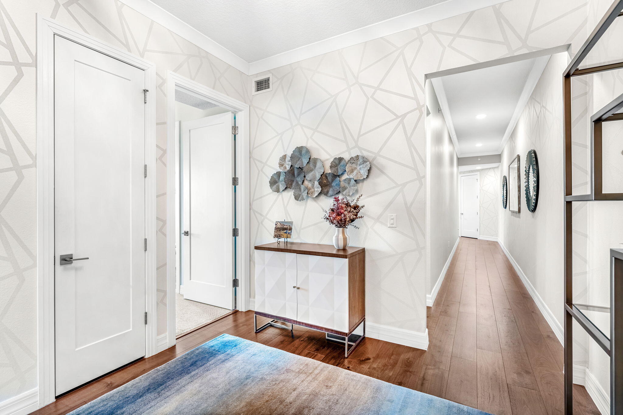 1725 North Hwy A1A, Unit 401 Indialantic, FL 32903 - Photo 24 of 39 a view of a hallway with wooden floor and staircase