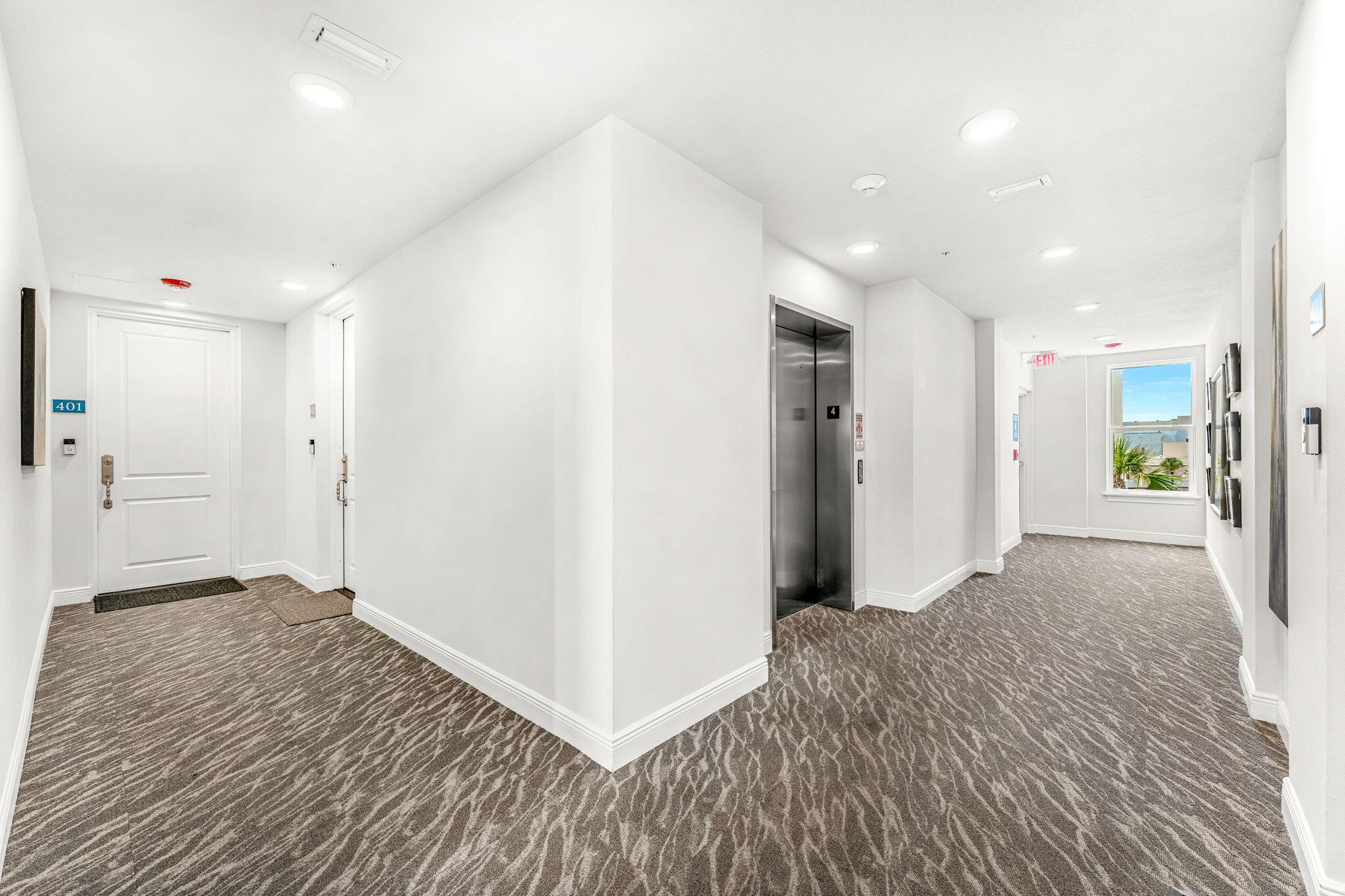 1725 North Hwy A1A, Unit 401 Indialantic, FL 32903 - Photo 28 of 39 a view of a hallway with wooden floor and a refrigerator