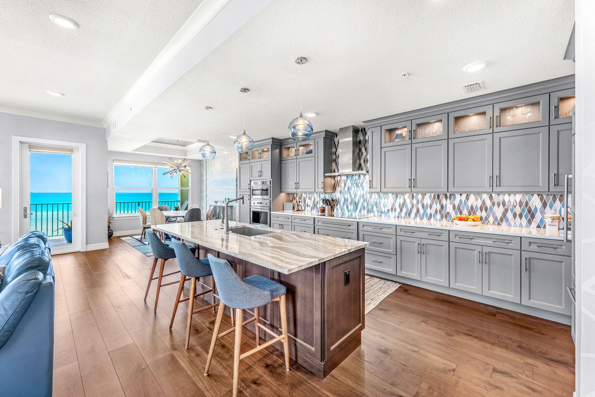 1725 North Hwy A1A, Unit 401 Indialantic, FL 32903 - Photo 5 of 39 a kitchen with stainless steel appliances kitchen island granite countertop a table chairs sink and cabinets