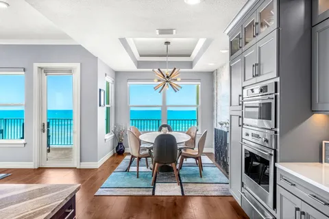 a balcony with table and chairs