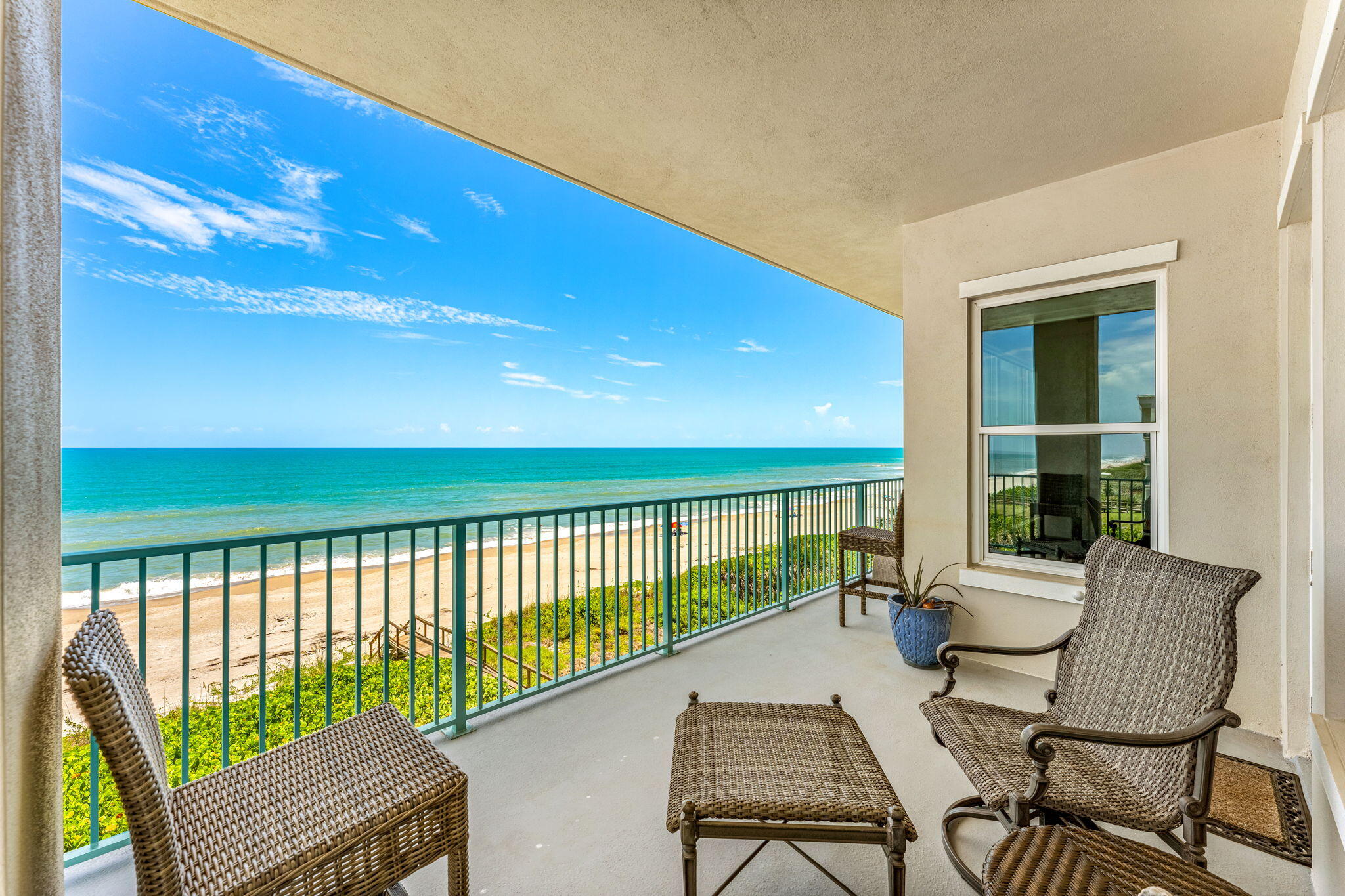 1725 North Hwy A1A, Unit 401 Indialantic, FL 32903 - Photo 10 of 39 a balcony with table and chairs