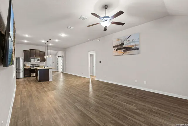 a view of a kitchen with a sink stainless steel appliances and cabinets