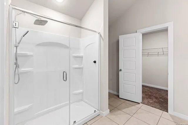 a bathroom with a glass shower door