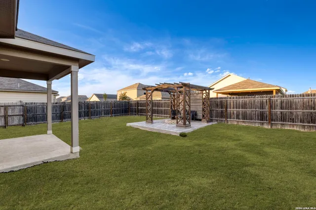 a view of a house with a backyard