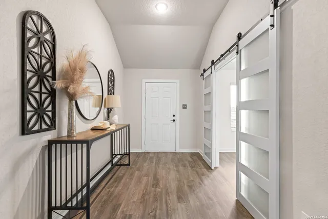 a view of a entryway door with wooden floor