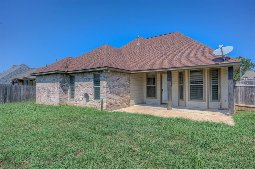 922 Antler Drive Haughton, LA 71037 - Photo 24 of 24 Brick exterior with a covered patio, brown shingle roof, and a privacy fence