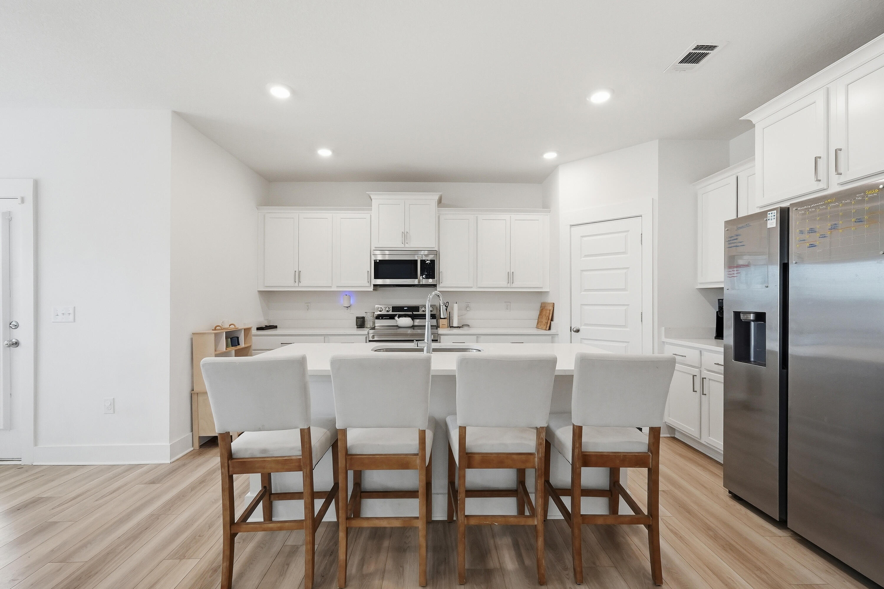 125 Blooming Cove Crestview, FL 32539 - Photo 31 of 55 a kitchen with kitchen island white cabinets and stainless steel appliances
