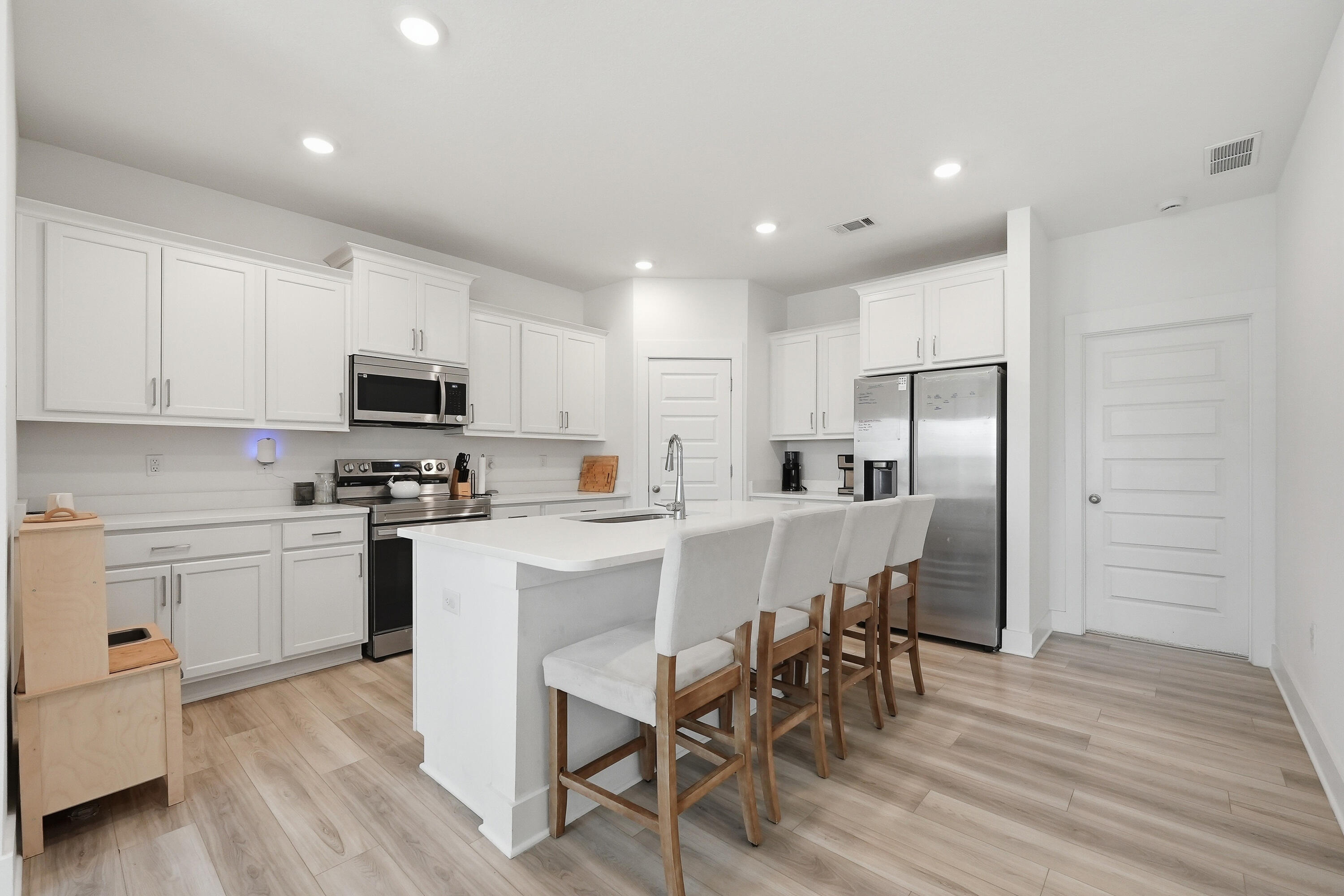 125 Blooming Cove Crestview, FL 32539 - Photo 8 of 55 a kitchen with white cabinets stainless steel appliances and dining table