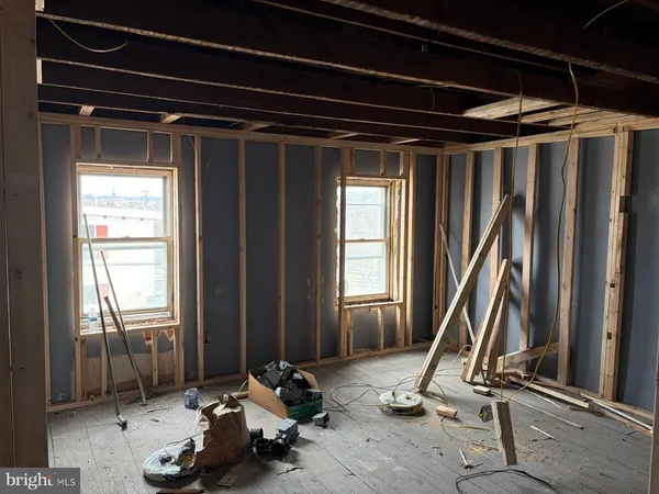 a view of a room with wooden floor and a window