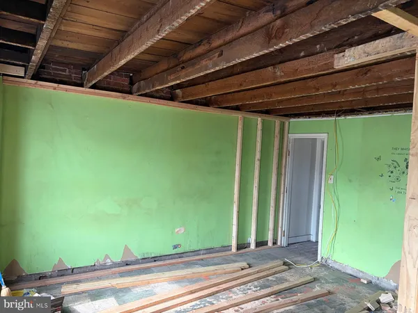 a room with water heater and wooden cabinets