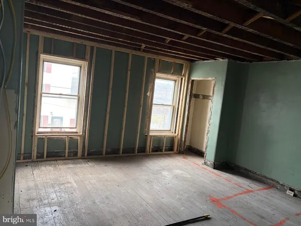 a bedroom with bed and a window