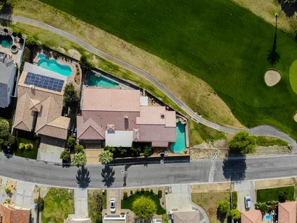 an aerial view of a house with a yard