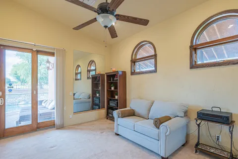 a hallway with a couch and chandelier