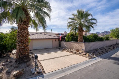 a view of house with palm tree