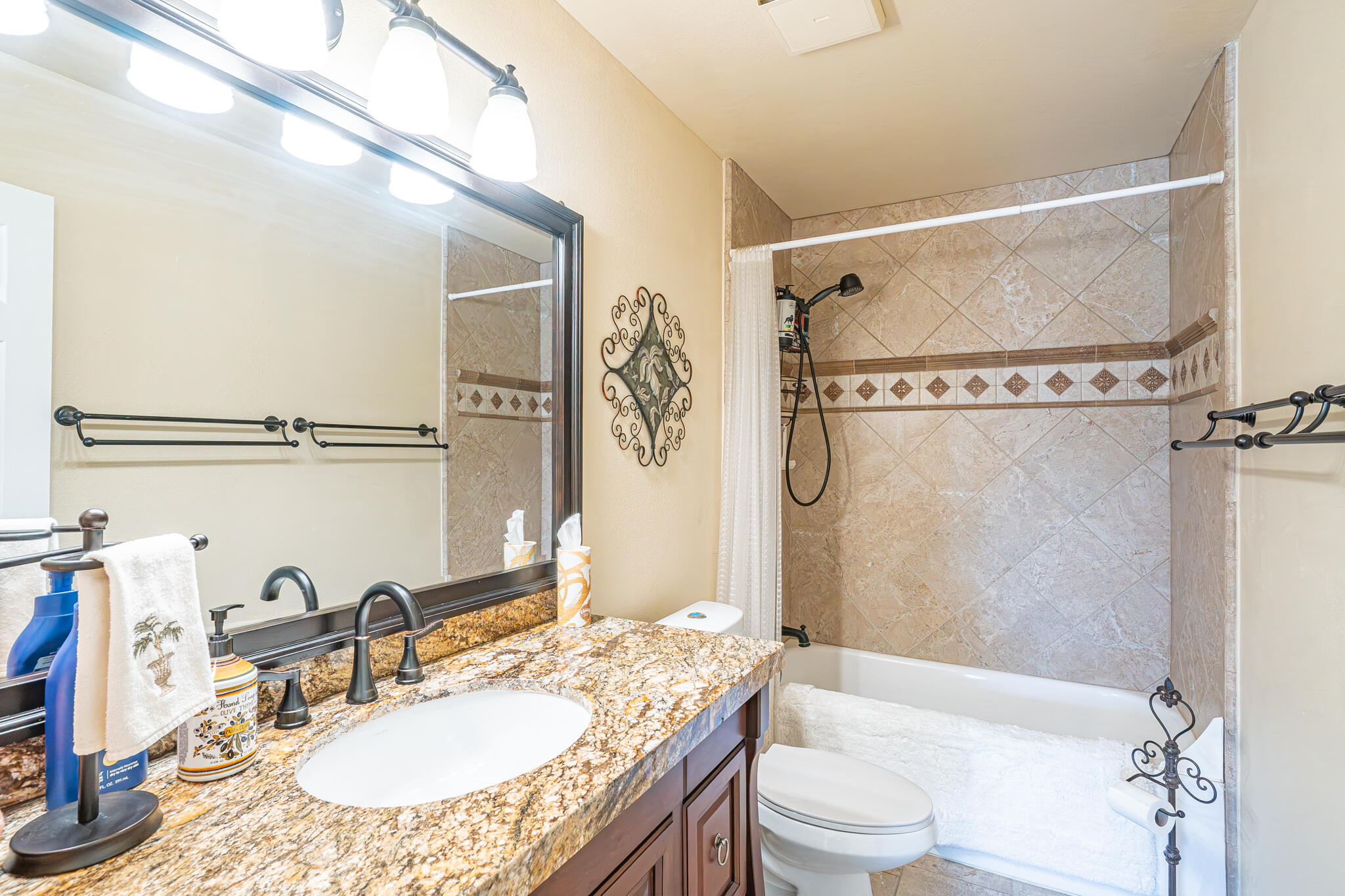 79815 Horseshoe Road La Quinta, CA 92253 - Photo 21 of 33 a bathroom with a granite countertop sink mirror vanity and toilet