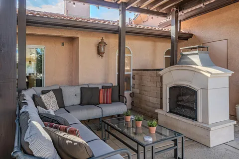 a view of a house with backyard porch and sitting area