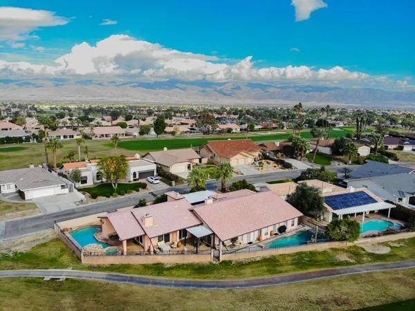 an aerial view of residential houses with outdoor space