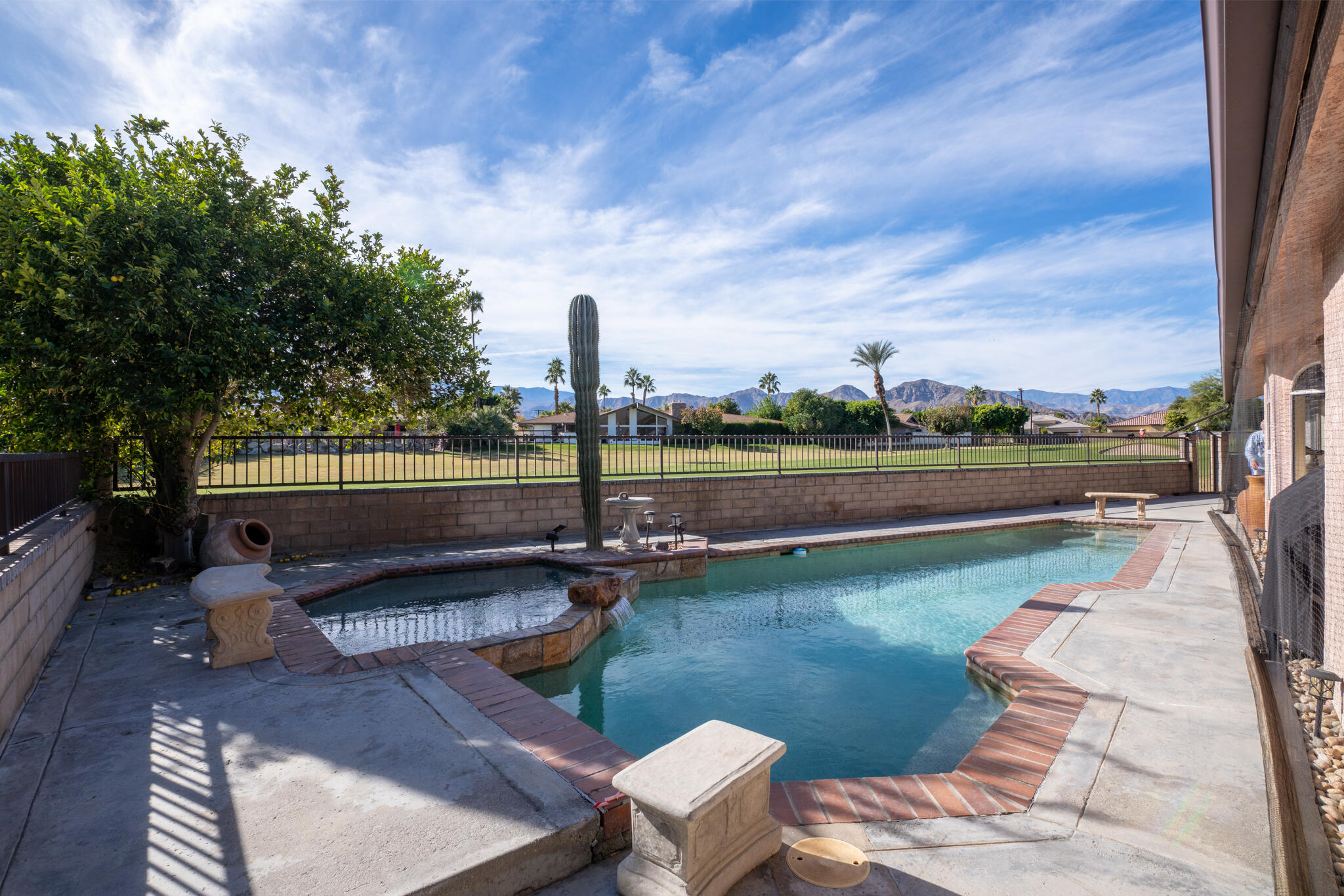 79815 Horseshoe Road La Quinta, CA 92253 - Photo 31 of 33 a view of a lake with a bench and trees around
