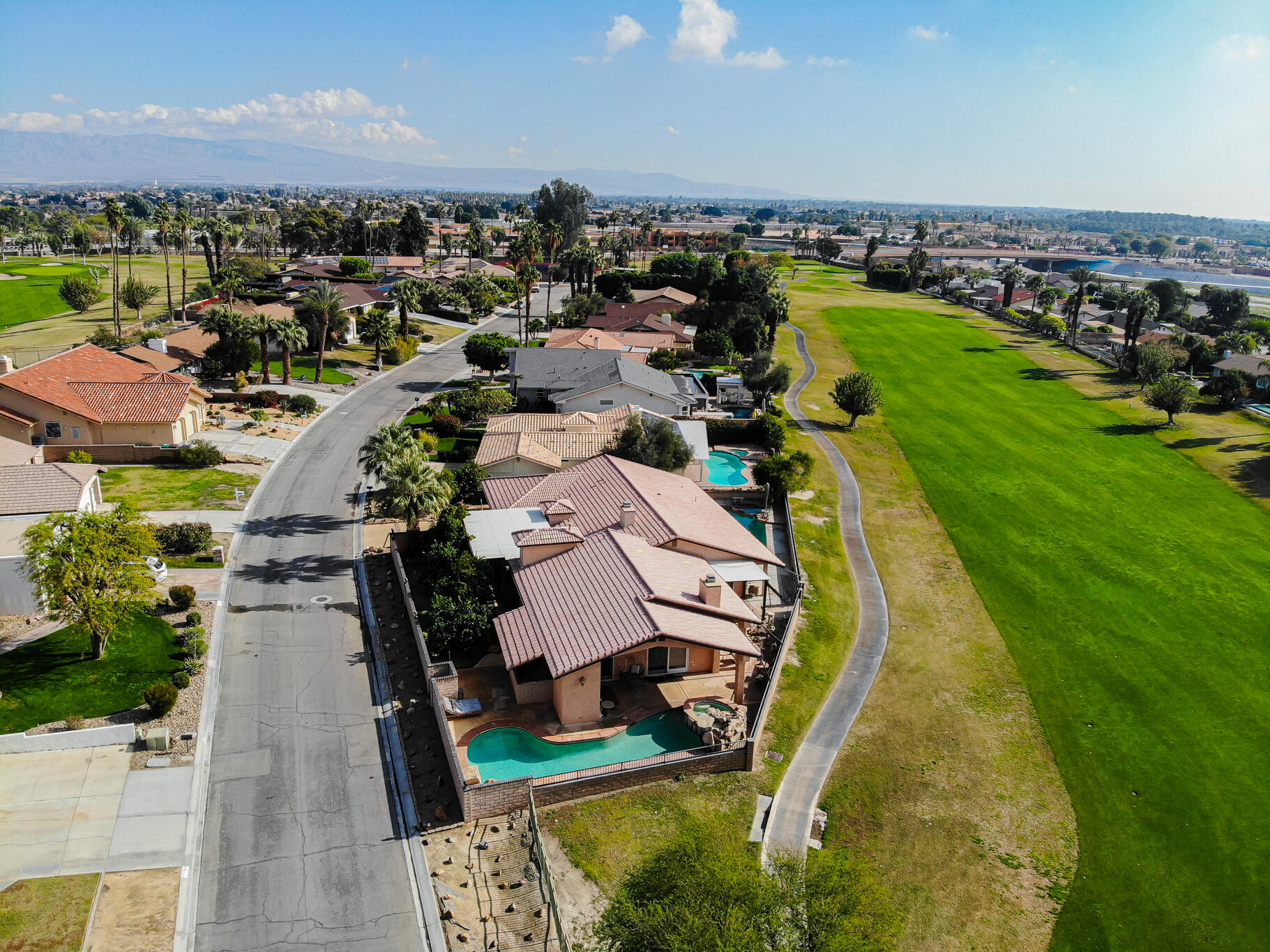 79815 Horseshoe Road La Quinta, CA 92253 - Photo 4 of 33 an aerial view of a house with a garden and lake view