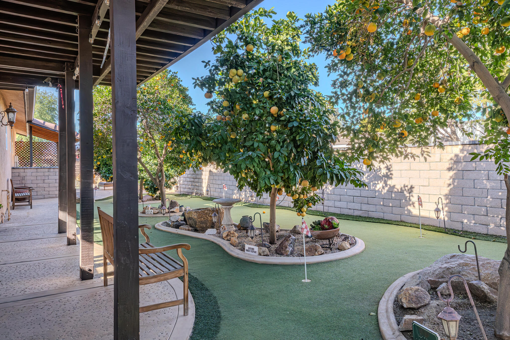 79815 Horseshoe Road La Quinta, CA 92253 - Photo 4 of 33 a view of a backyard with table and chairs potted plants and wooden fence