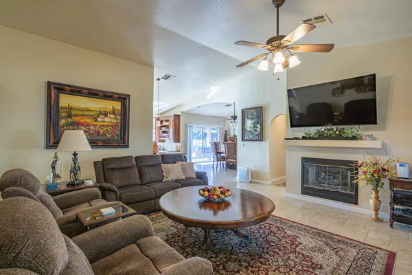 a living room with furniture a fireplace and a flat screen tv