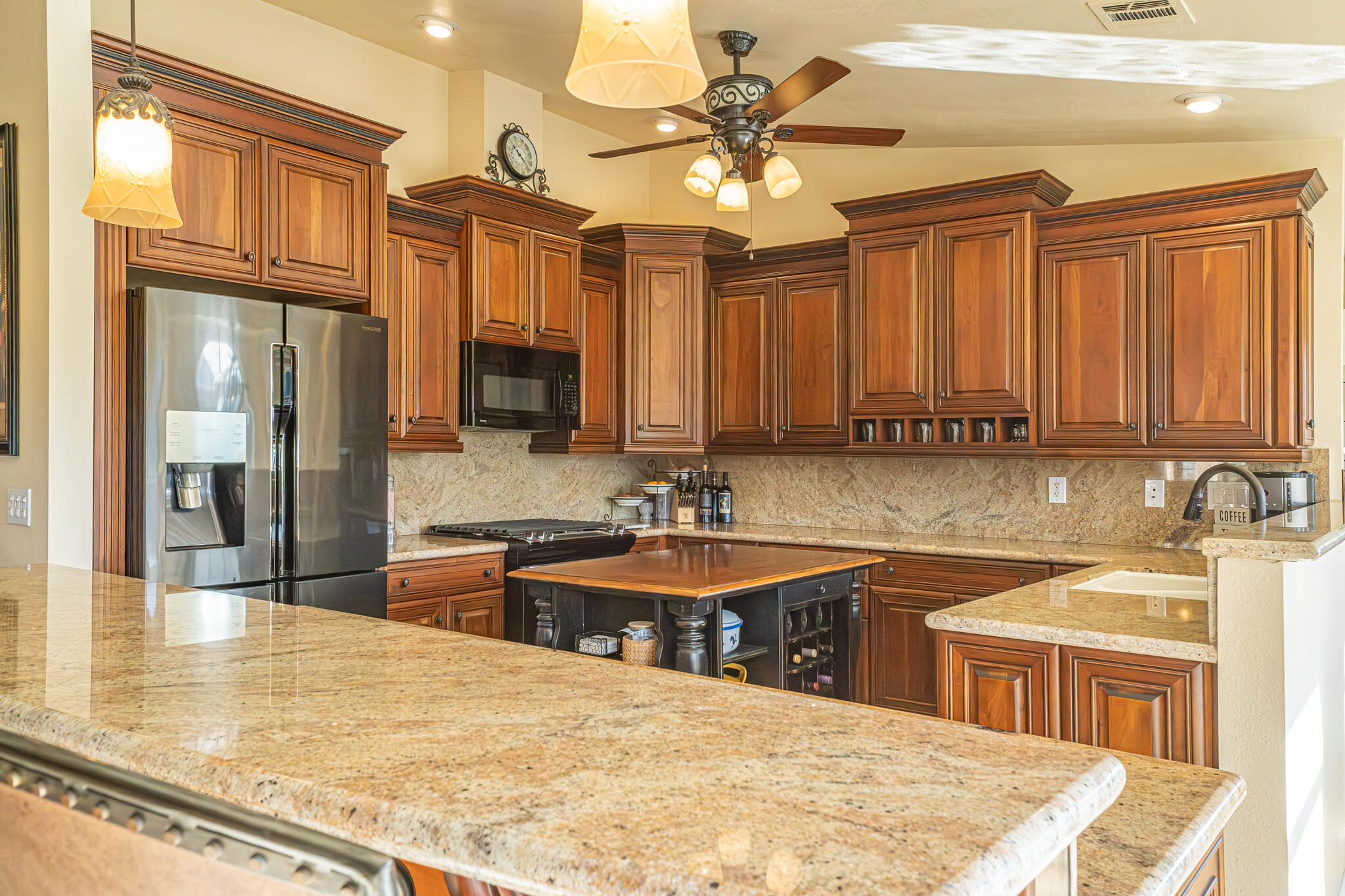 79815 Horseshoe Road La Quinta, CA 92253 - Photo 8 of 33 a kitchen with stainless steel appliances granite countertop a sink a stove cabinets counter space and a window