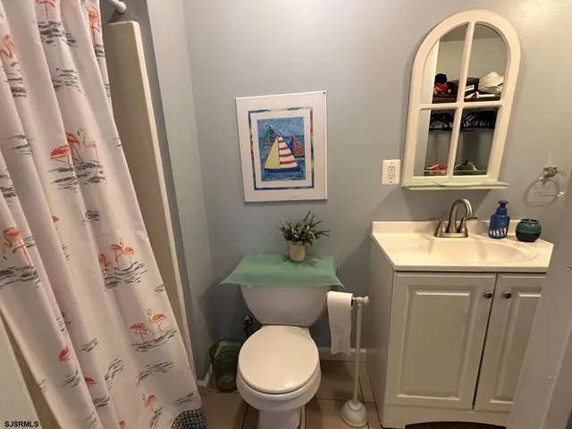a bathroom with a toilet a sink and a mirror