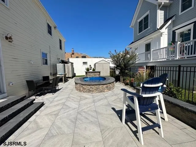 a view of a patio with table and chairs potted plants with wooden fence