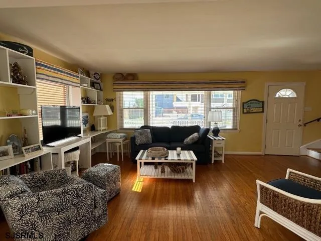 a living room with furniture and a flat screen tv