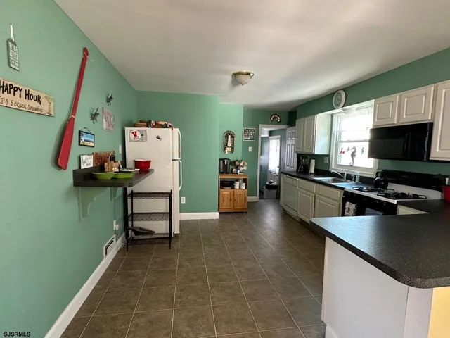 a kitchen with a refrigerator and a sink
