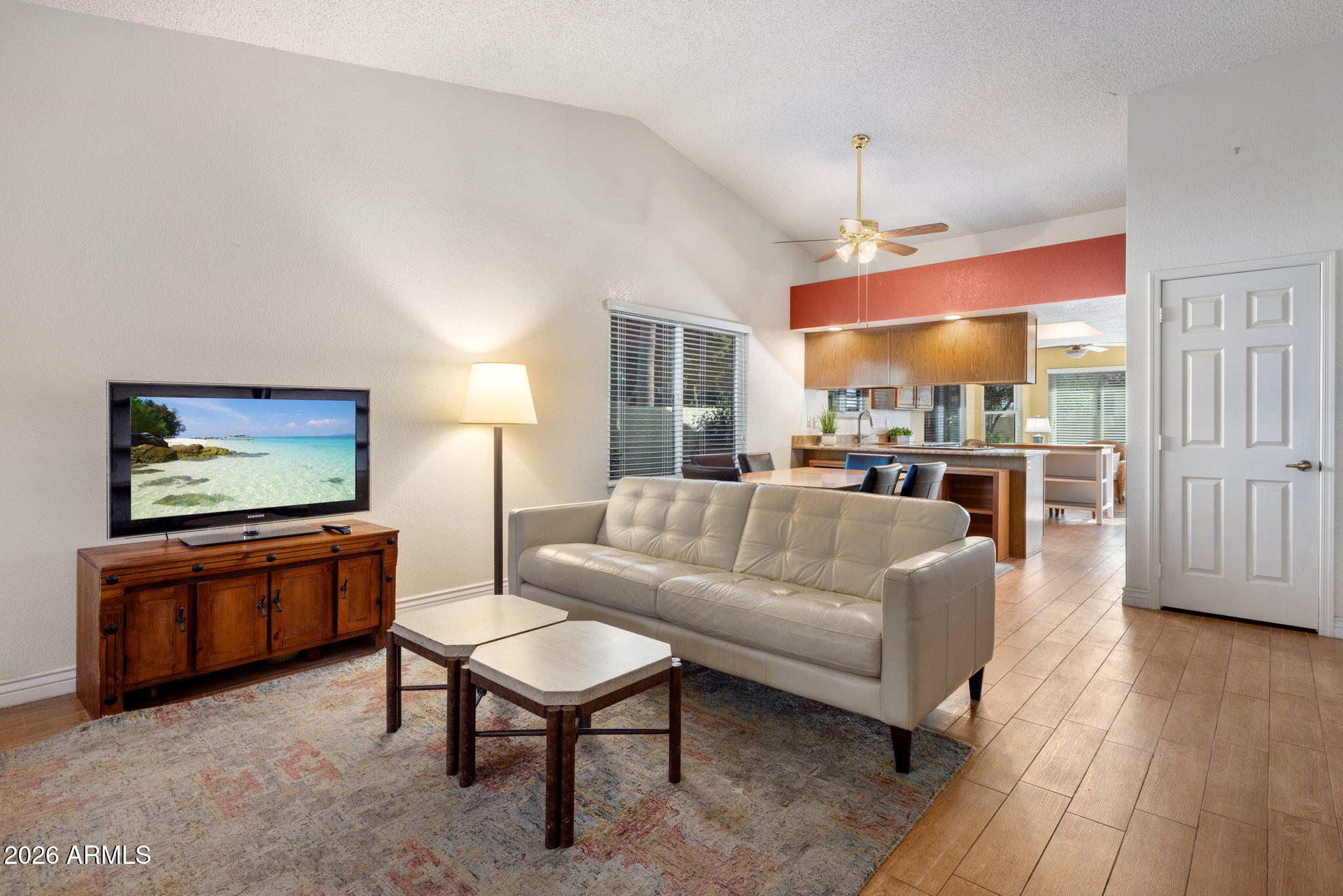 542 South Higley Road, Unit 54 Mesa, AZ 85206 - Photo 4 of 29 a living room with furniture a dining table and a wooden floor