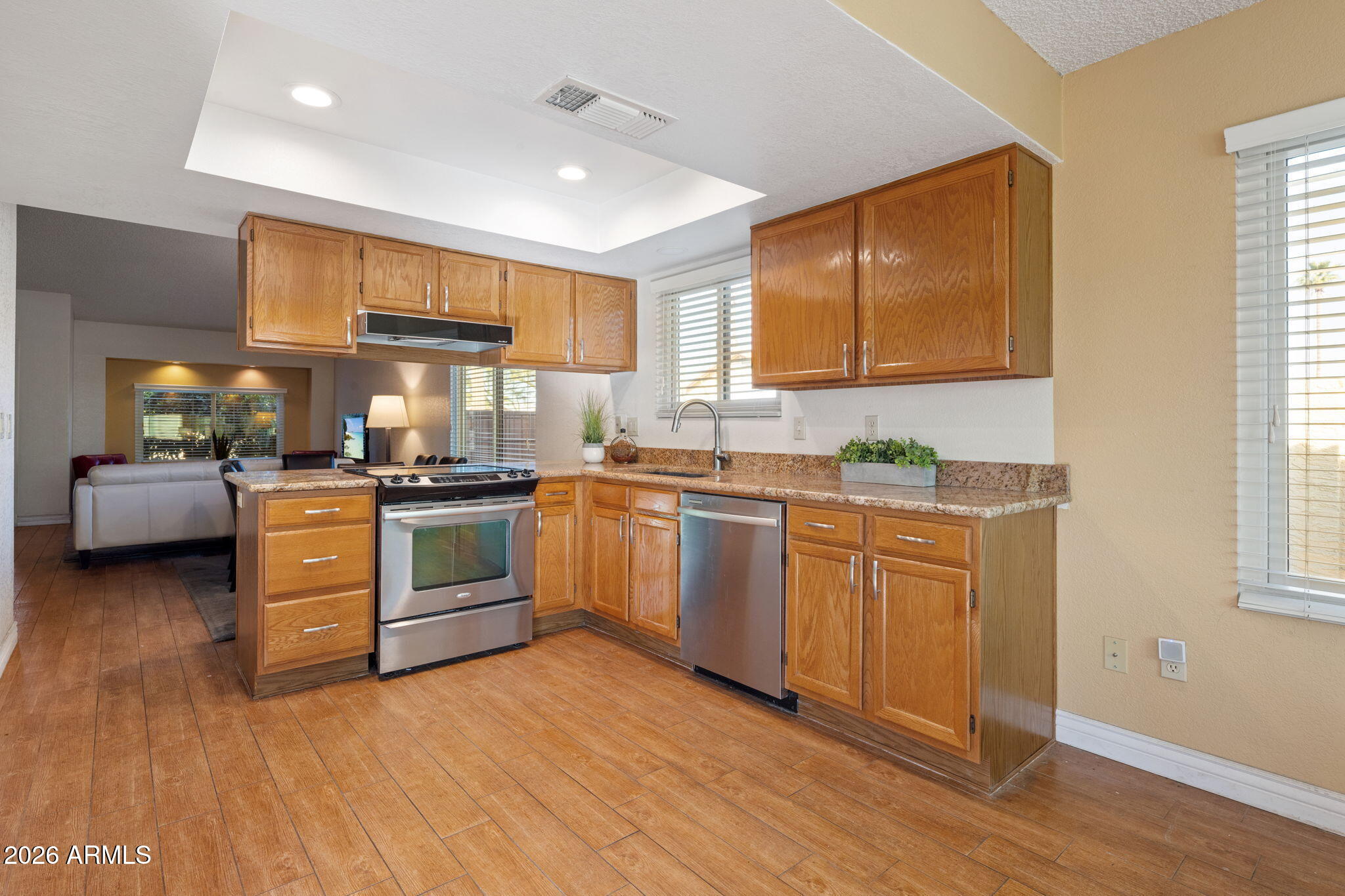 542 South Higley Road, Unit 54 Mesa, AZ 85206 - Photo 6 of 29 a kitchen with granite countertop a sink cabinets stainless steel appliances and a window