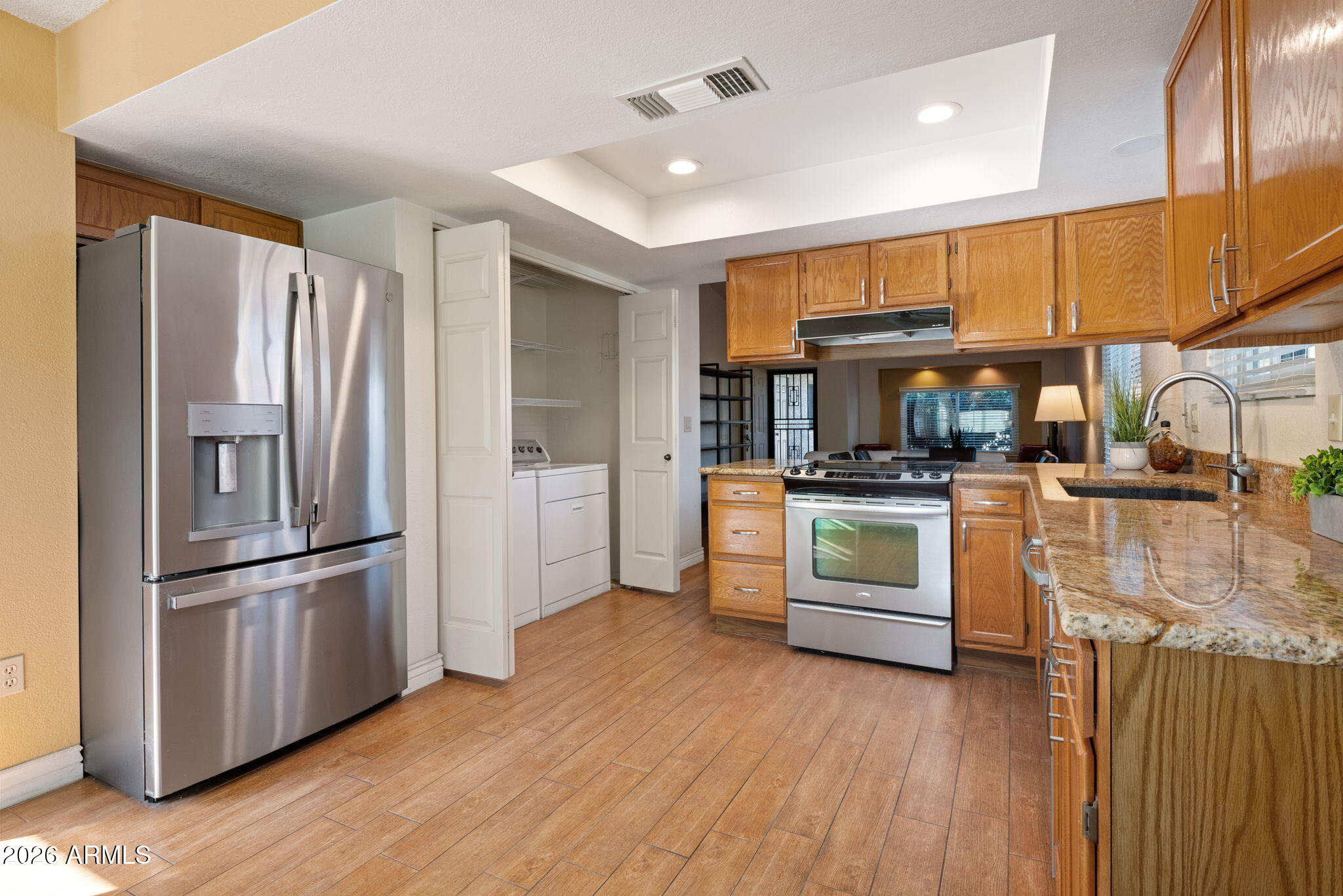 542 South Higley Road, Unit 54 Mesa, AZ 85206 - Photo 7 of 29 a kitchen with white cabinets and stainless steel appliances