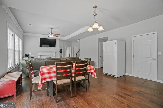 a view of a dining room with furniture and wooden floor
