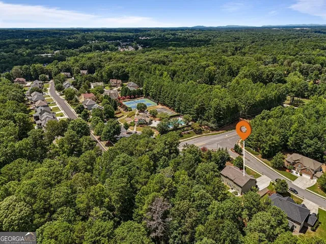 an aerial view of a house with a yard