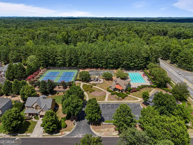 an aerial view of a house with a yard and lake view