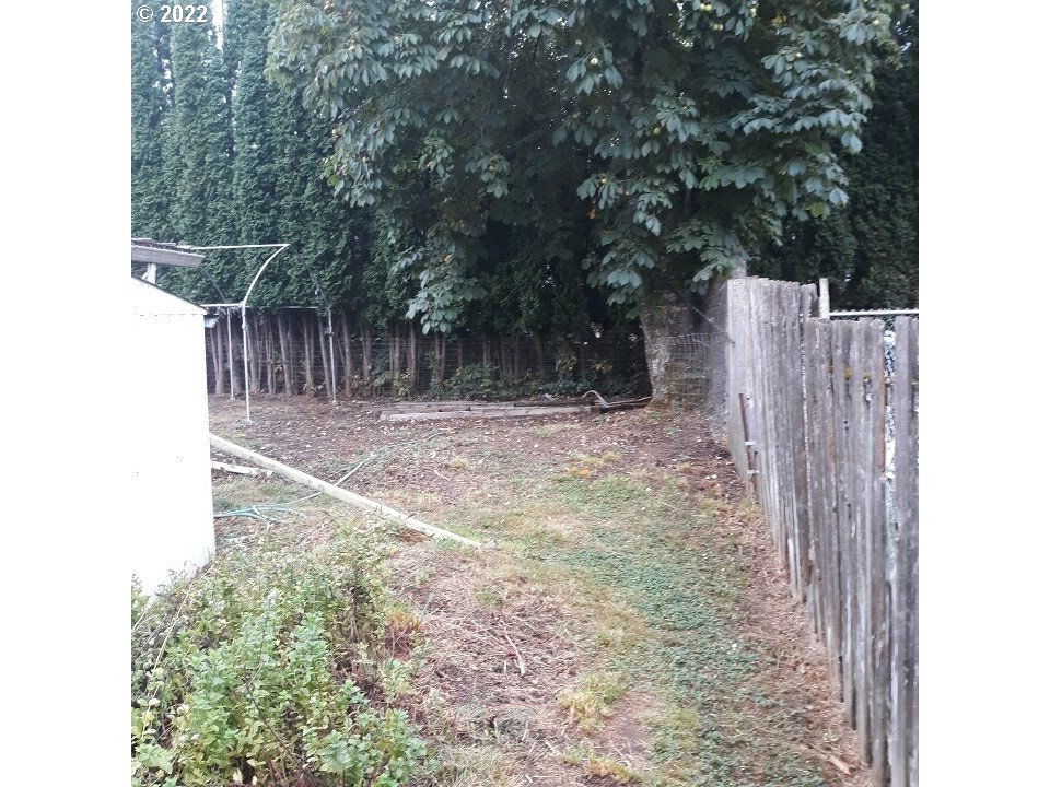 1223 Southeast Barnes Road Gresham, OR 97080 - Photo 8 of 12 a view of a backyard with wooden fence