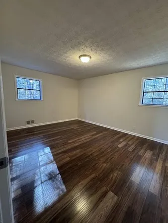 a view of room with wooden floor