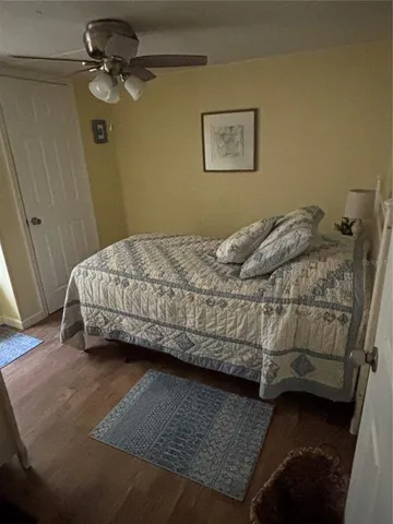 a bedroom with a bed and ceiling fan