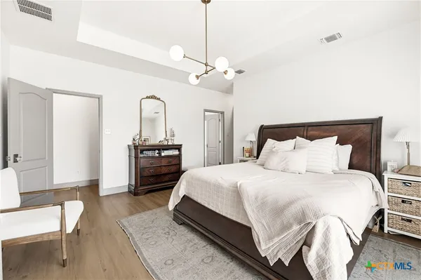 a bathroom with a granite countertop toilet a sink and a mirror
