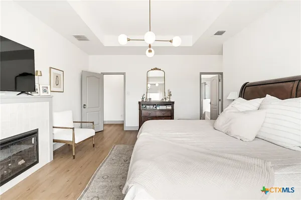 a bedroom with a bed and a chandelier