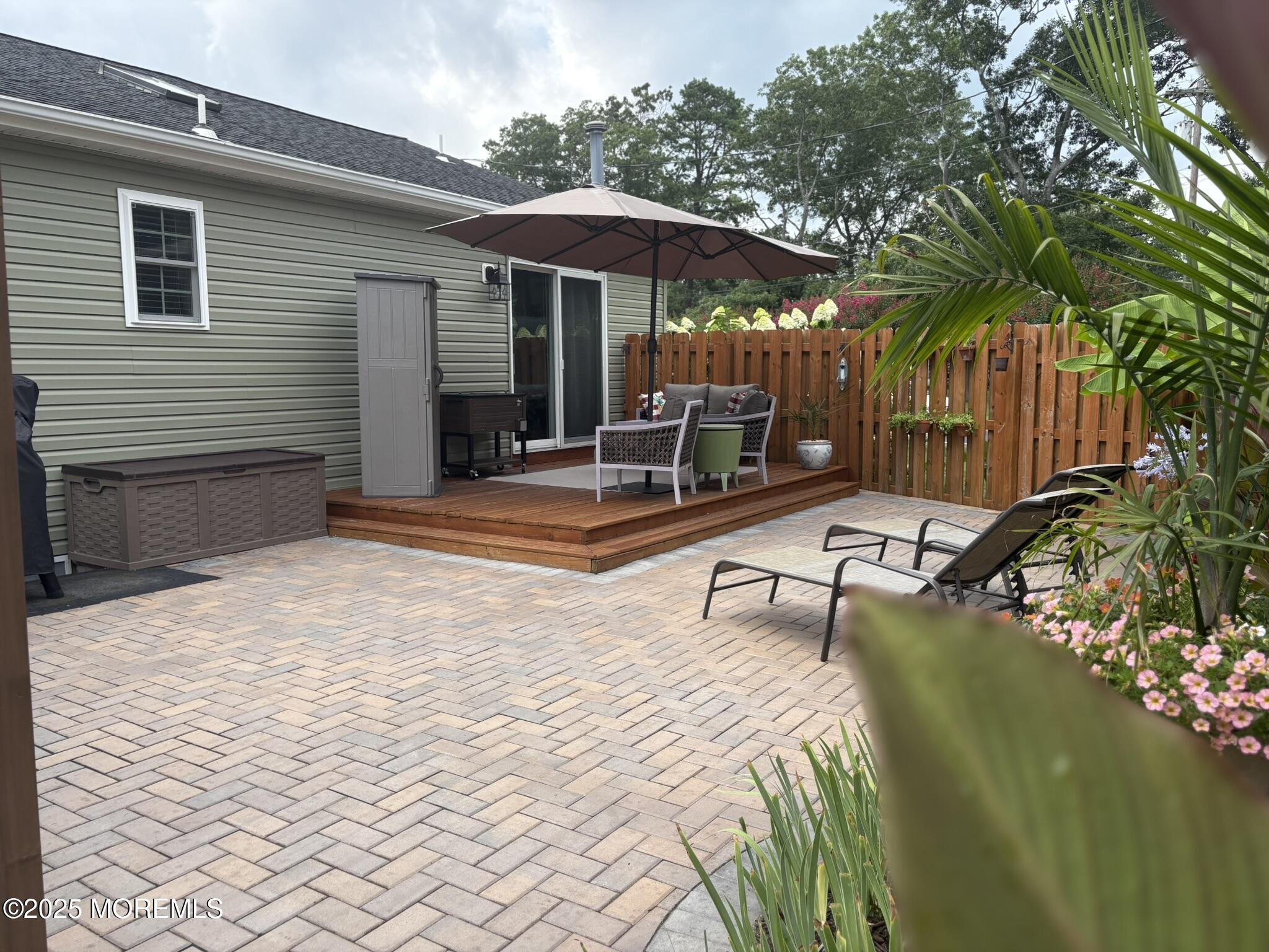 650 Chelsea Street Forked River, NJ 08731 - Photo 33 of 82 a view of a patio with a table and chairs under an umbrella
