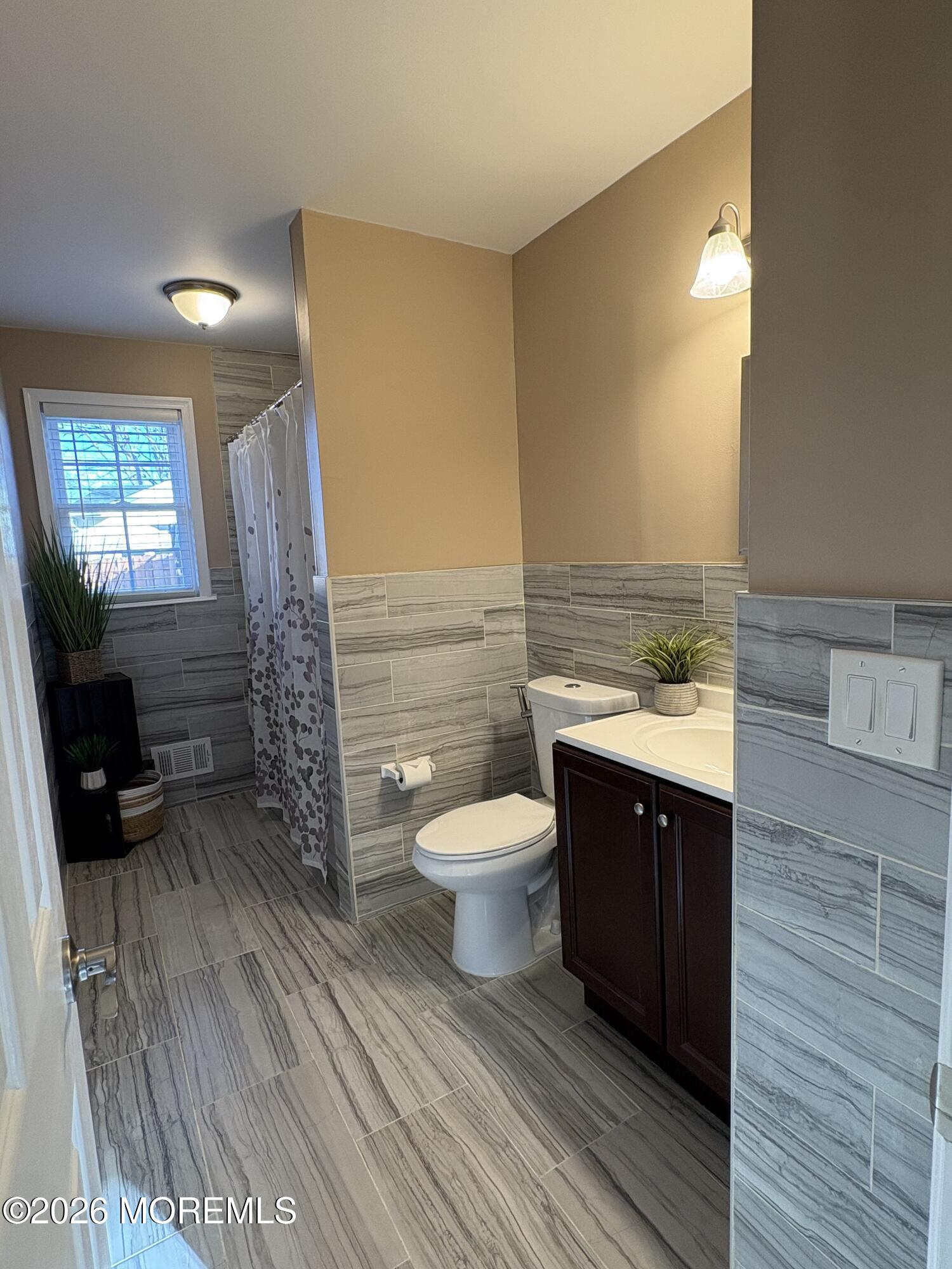 650 Chelsea Street Forked River, NJ 08731 - Photo 54 of 82 a bathroom with a toilet a sink and mirror