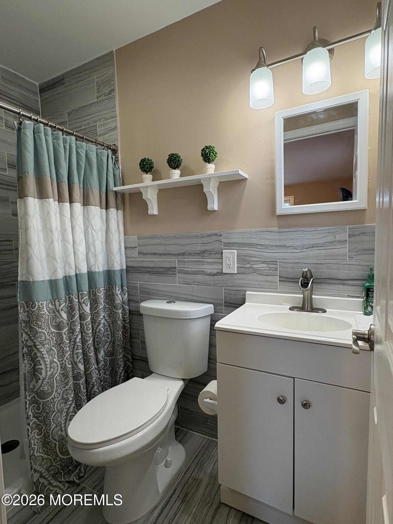 650 Chelsea Street Forked River, NJ 08731 - Photo 60 of 82 a bathroom with a toilet sink and mirror