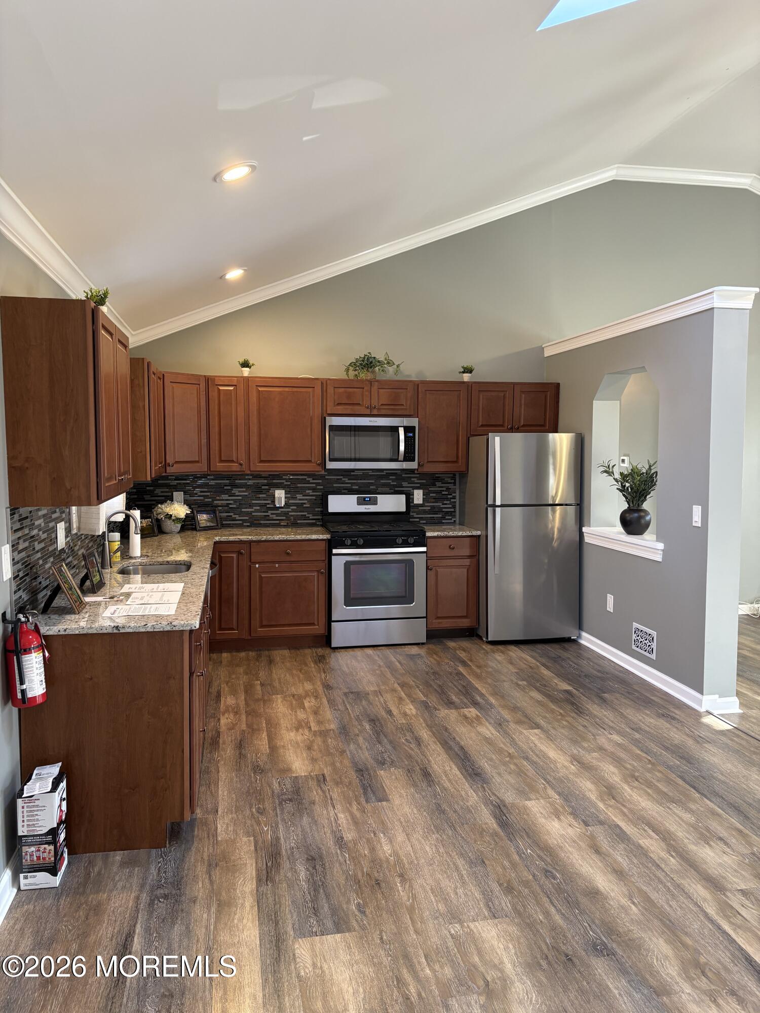 650 Chelsea Street Forked River, NJ 08731 - Photo 7 of 82 a kitchen with stainless steel appliances granite countertop a refrigerator stove and oven